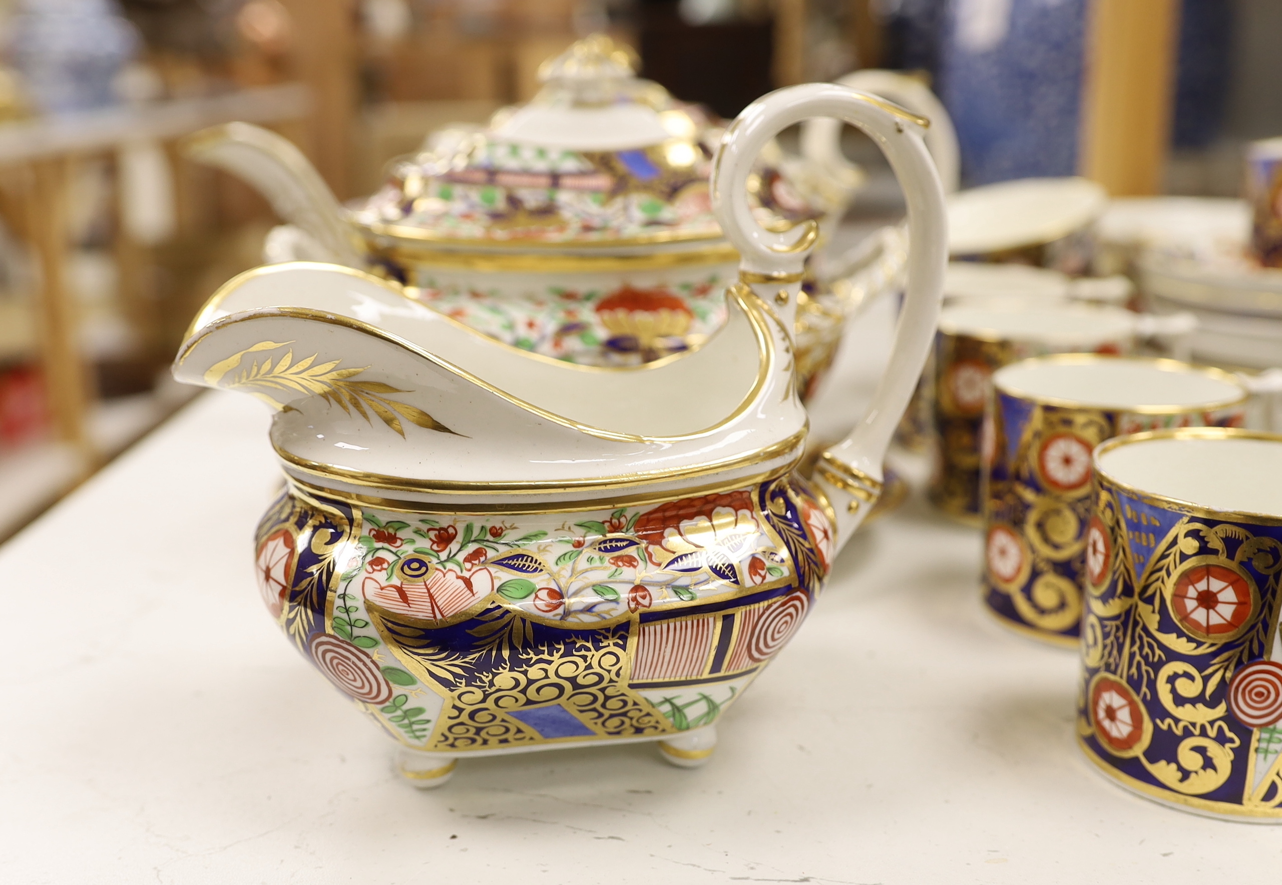 An early 19th century Derby Japan pattern part tea and coffee set, including cups and saucers, teapot, milk jug and bowl